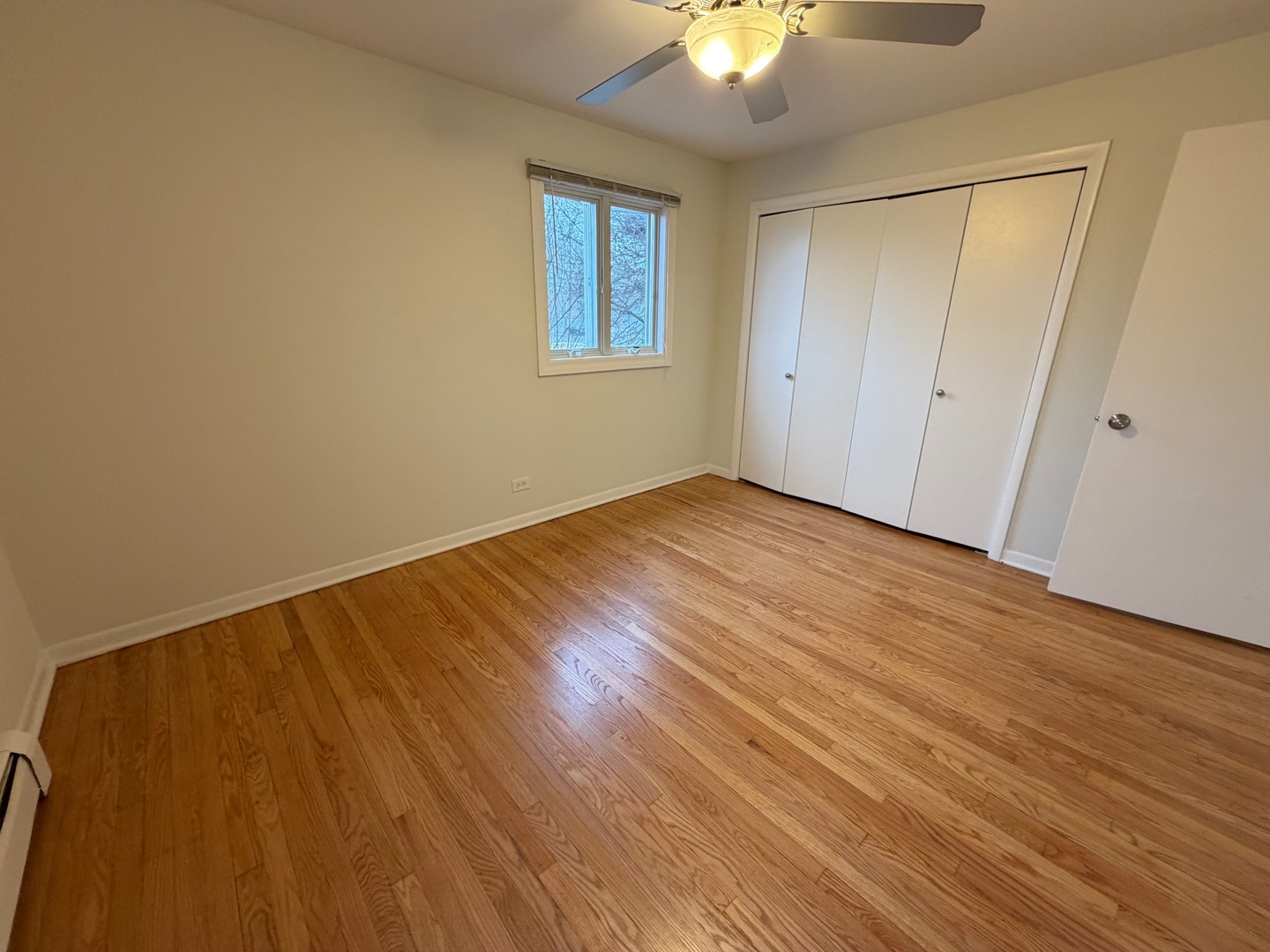 84 West Belvidere Road, Unit 203 Grayslake, IL 60030 - Photo 12 of 15 a view of an empty room with wooden floor and a window