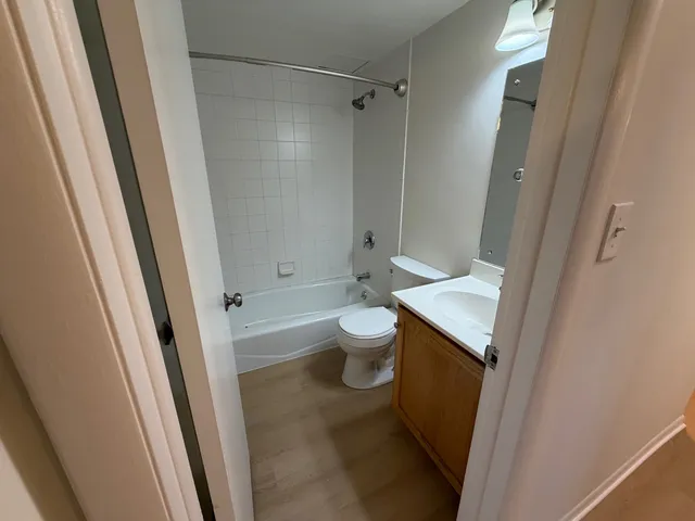 a bathroom with a sink a toilet and a shower