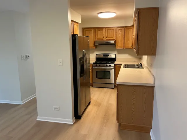 a kitchen with a refrigerator stove and sink