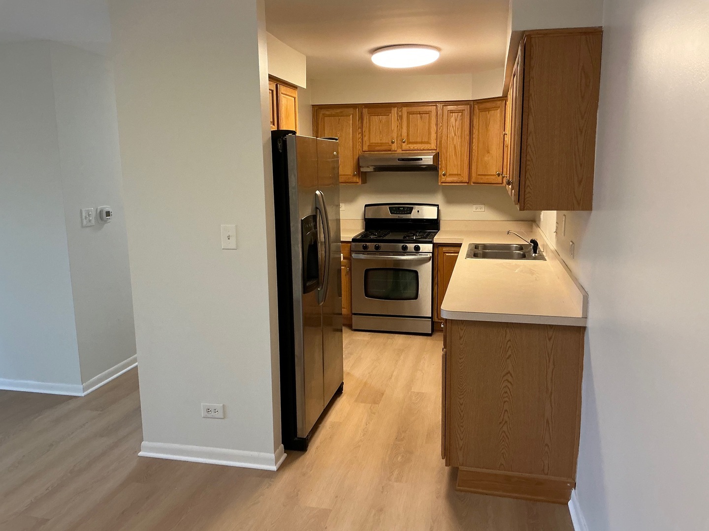84 West Belvidere Road, Unit 203 Grayslake, IL 60030 - Photo 4 of 15 a kitchen with a refrigerator stove and sink