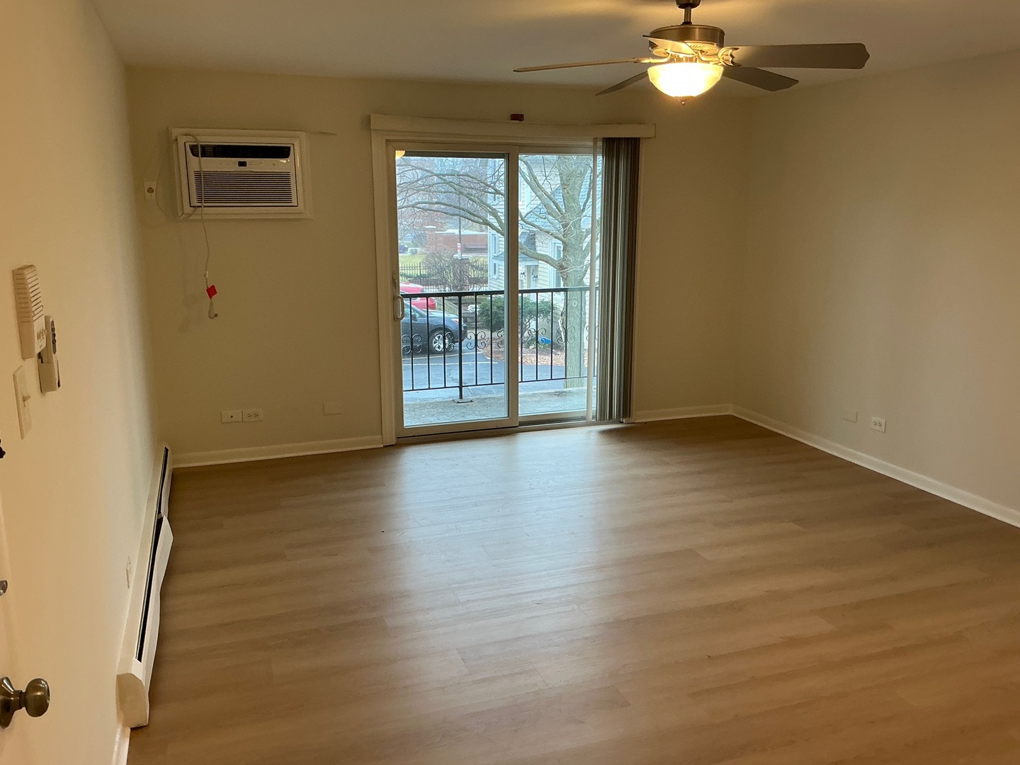 84 West Belvidere Road, Unit 203 Grayslake, IL 60030 - Photo 6 of 15 a view of an empty room with wooden floor and a window