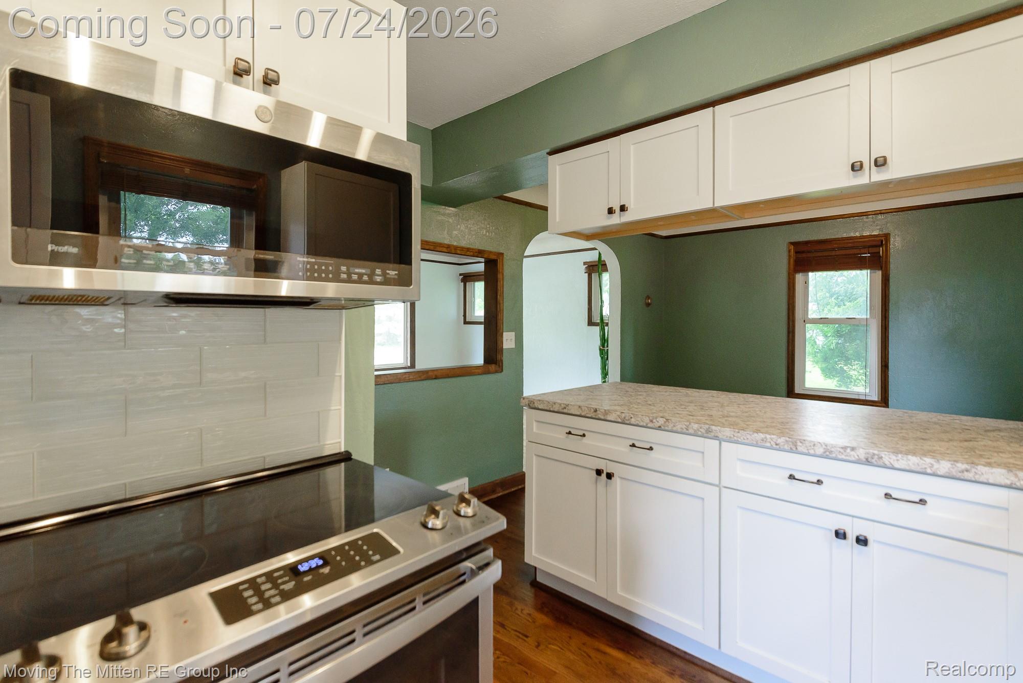 2037 Vivian Road Monroe, MI 48162 - Photo 11 of 39 Modern kitchen space featuring white shaker-style cabinetry with dark hardware