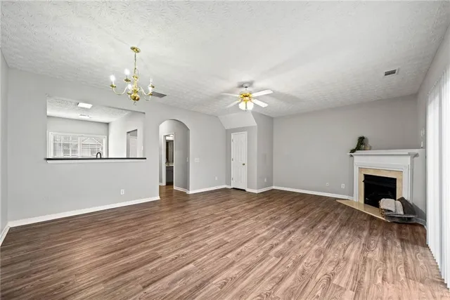 a view of livingroom with fireplace wooden floor and workspace