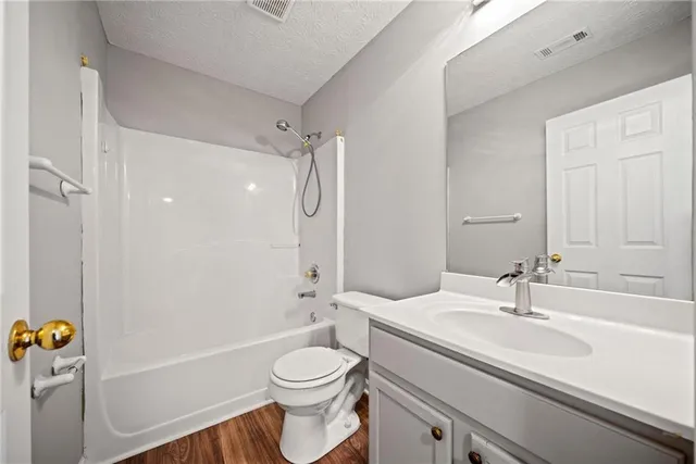 a bathroom with a sink toilet a shower and a mirror