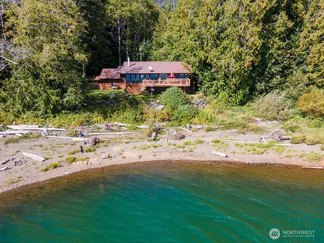 a backyard of a house with a yard and outdoor seating