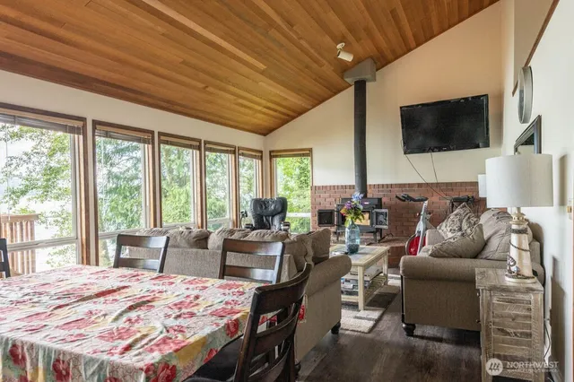 a living room with furniture a flat screen tv and a floor to ceiling window