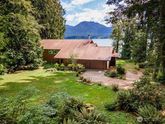 a view of a house with a tree in the yard