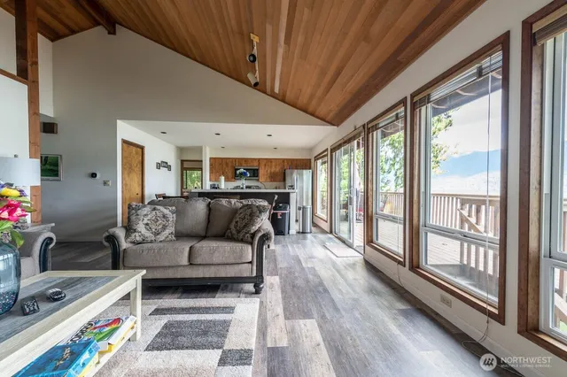 a living room with furniture and a floor to ceiling window
