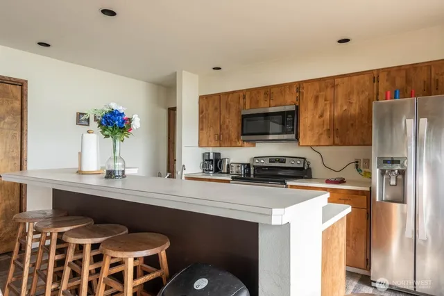 a kitchen with a sink appliances and cabinets
