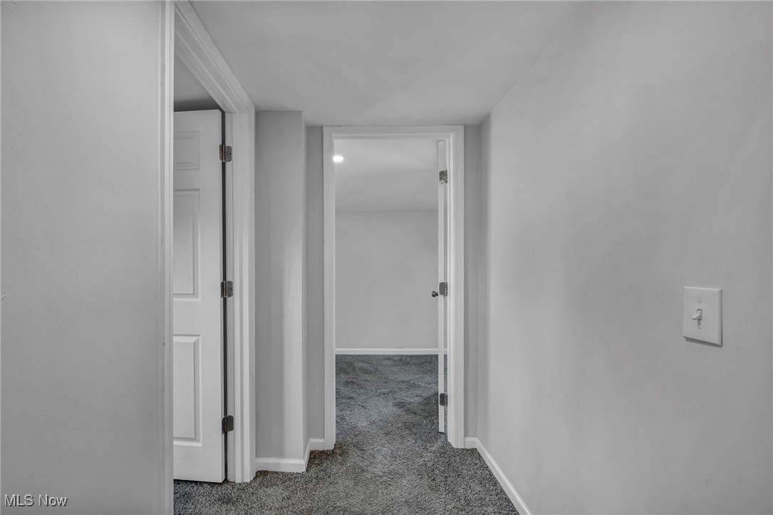 4649 Burleigh Road Cleveland, OH 44125 - Photo 36 of 37 Hallway with dark carpet and baseboards