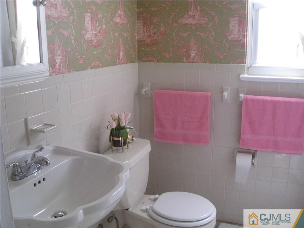 3 Wynn Road Edison, NJ 08817 - Photo 11 of 13 a bathroom with a sink a toilet and shower curtain