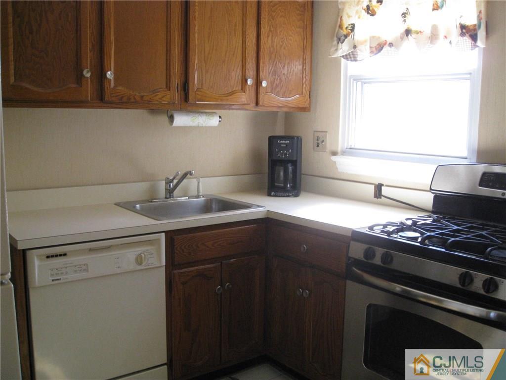 3 Wynn Road Edison, NJ 08817 - Photo 5 of 13 a kitchen with a sink stove and cabinets