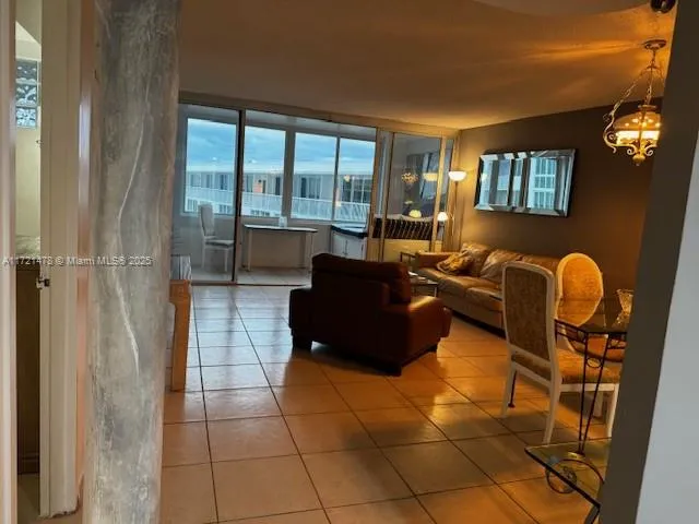 a living room with furniture and a floor to ceiling window