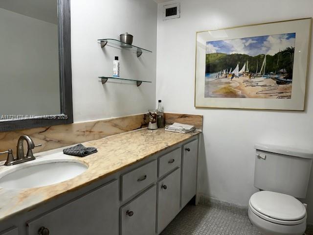 5401 Collins Avenue, Unit 430 Miami Beach, FL 33140 - Photo 20 of 52 a bathroom with a granite countertop sink mirror and toilet