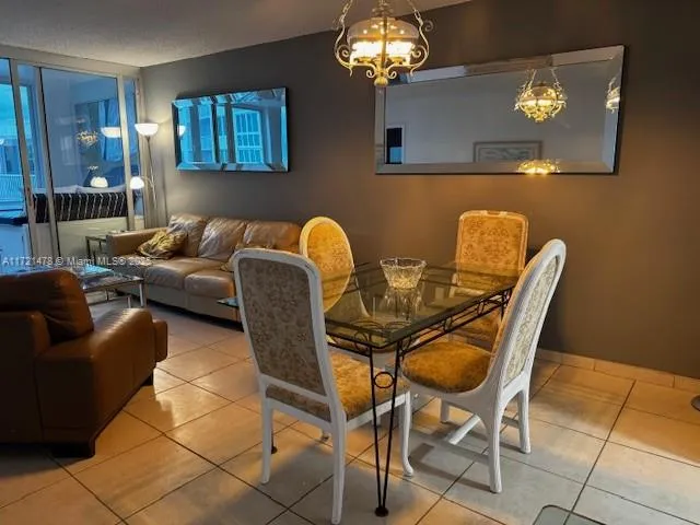 a living room with furniture a chandelier and a window