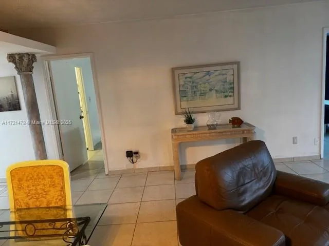 a living room with furniture and a mirror