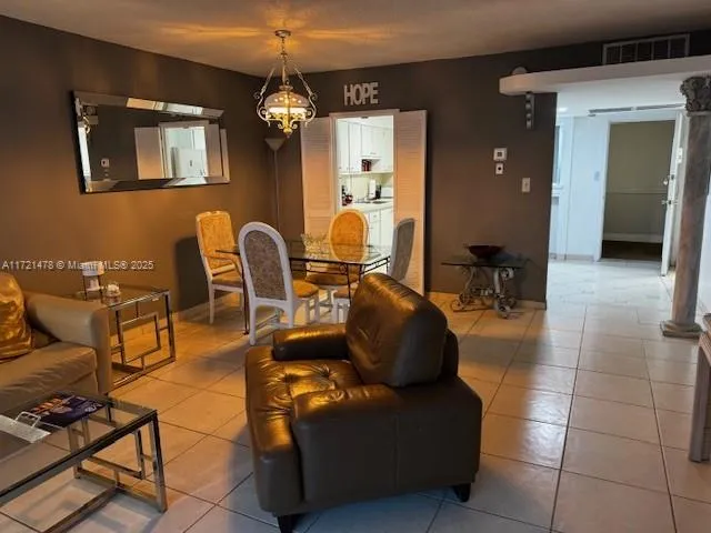 a living room with couches chairs and next to a window