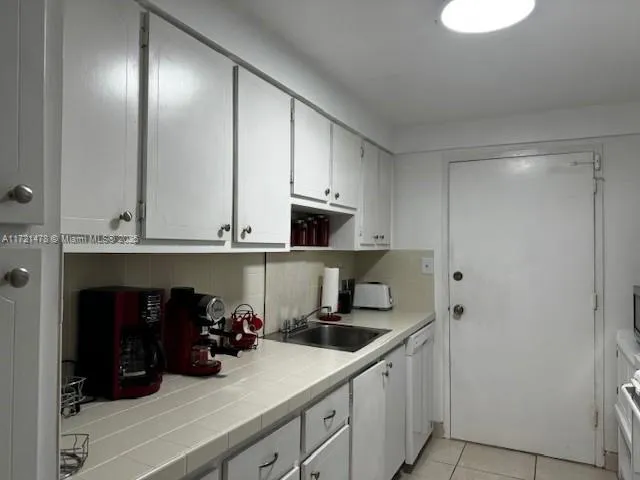 a kitchen with a sink and cabinets