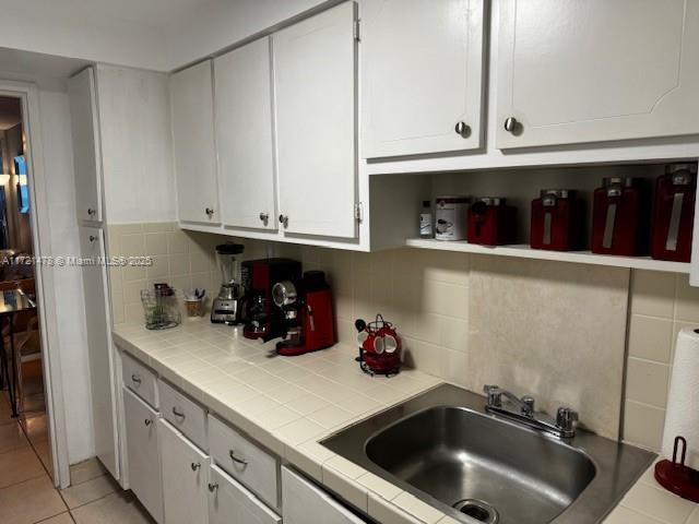 5401 Collins Avenue, Unit 430 Miami Beach, FL 33140 - Photo 29 of 52 a kitchen with stainless steel appliances a sink a stove and cabinets