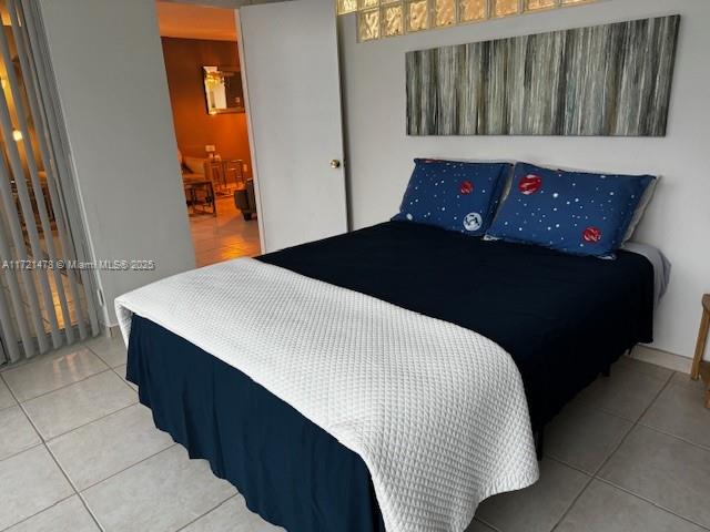 5401 Collins Avenue, Unit 430 Miami Beach, FL 33140 - Photo 37 of 52 a bedroom with a bed and wooden floor