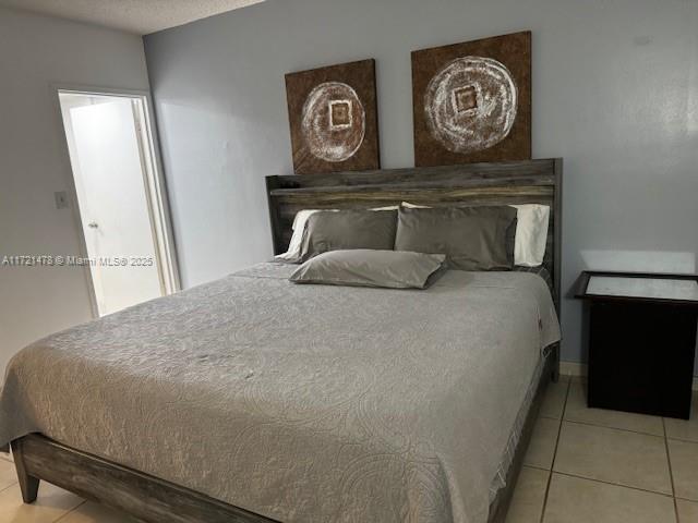 5401 Collins Avenue, Unit 430 Miami Beach, FL 33140 - Photo 39 of 52 a bedroom with a bed and painting on the wall