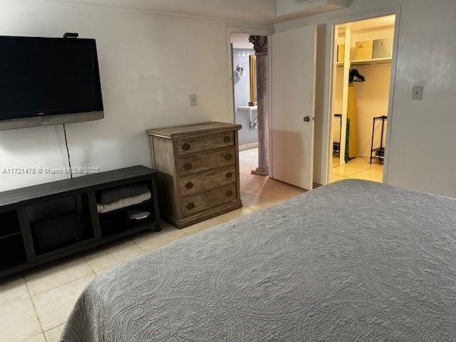 5401 Collins Avenue, Unit 430 Miami Beach, FL 33140 - Photo 40 of 52 a spacious bedroom with a bed and a flat screen tv