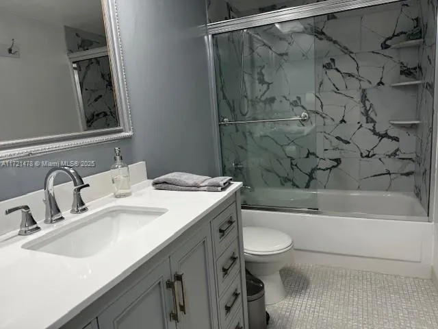 a bathroom with a sink toilet vanity and shower