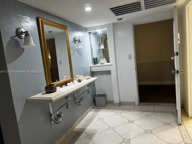 a bathroom with a sink a toilet and mirror