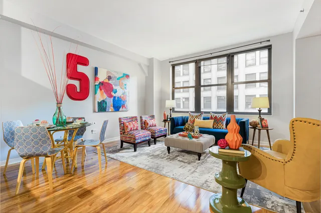a living room filled with furniture and floor to ceiling windows