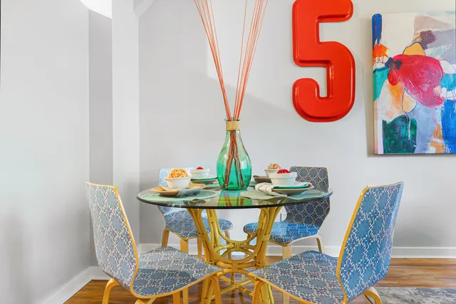 a view of a dining room with furniture and chandelier