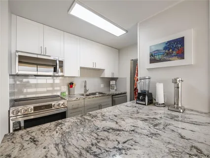 a kitchen with stainless steel appliances and a stove top oven