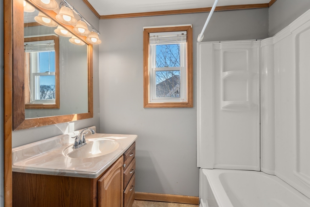 21 Crescent Street Whitman, MA 02382 - Photo 13 of 26 a bathroom with a sink and a mirror