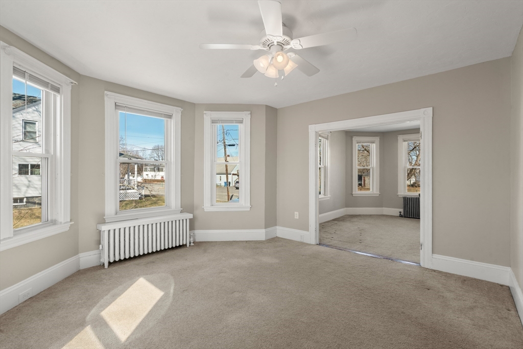 21 Crescent Street Whitman, MA 02382 - Photo 4 of 26 an empty room with windows and closet