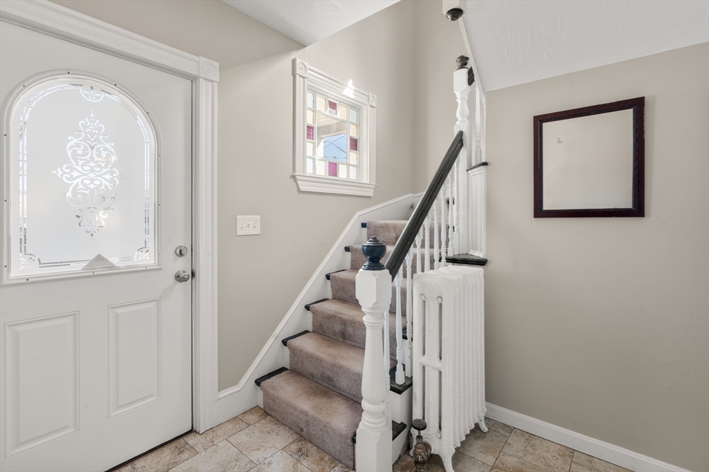 21 Crescent Street Whitman, MA 02382 - Photo 7 of 26 a view of entryway with wooden floor and stair