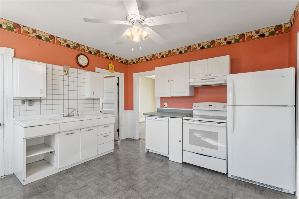 21 Crescent Street Whitman, MA 02382 - Photo 8 of 26 a kitchen with white cabinets and white appliances