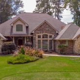 a front view of a house with a yard and porch