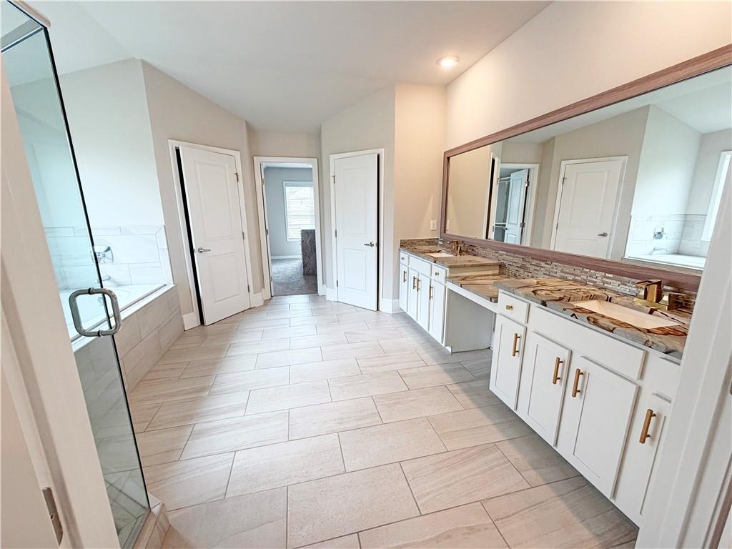 5296 Cheval Rue Court Suwanee, GA 30024 - Photo 23 of 51 a large white kitchen with stainless steel appliances granite countertop a stove a sink and a refrigerator