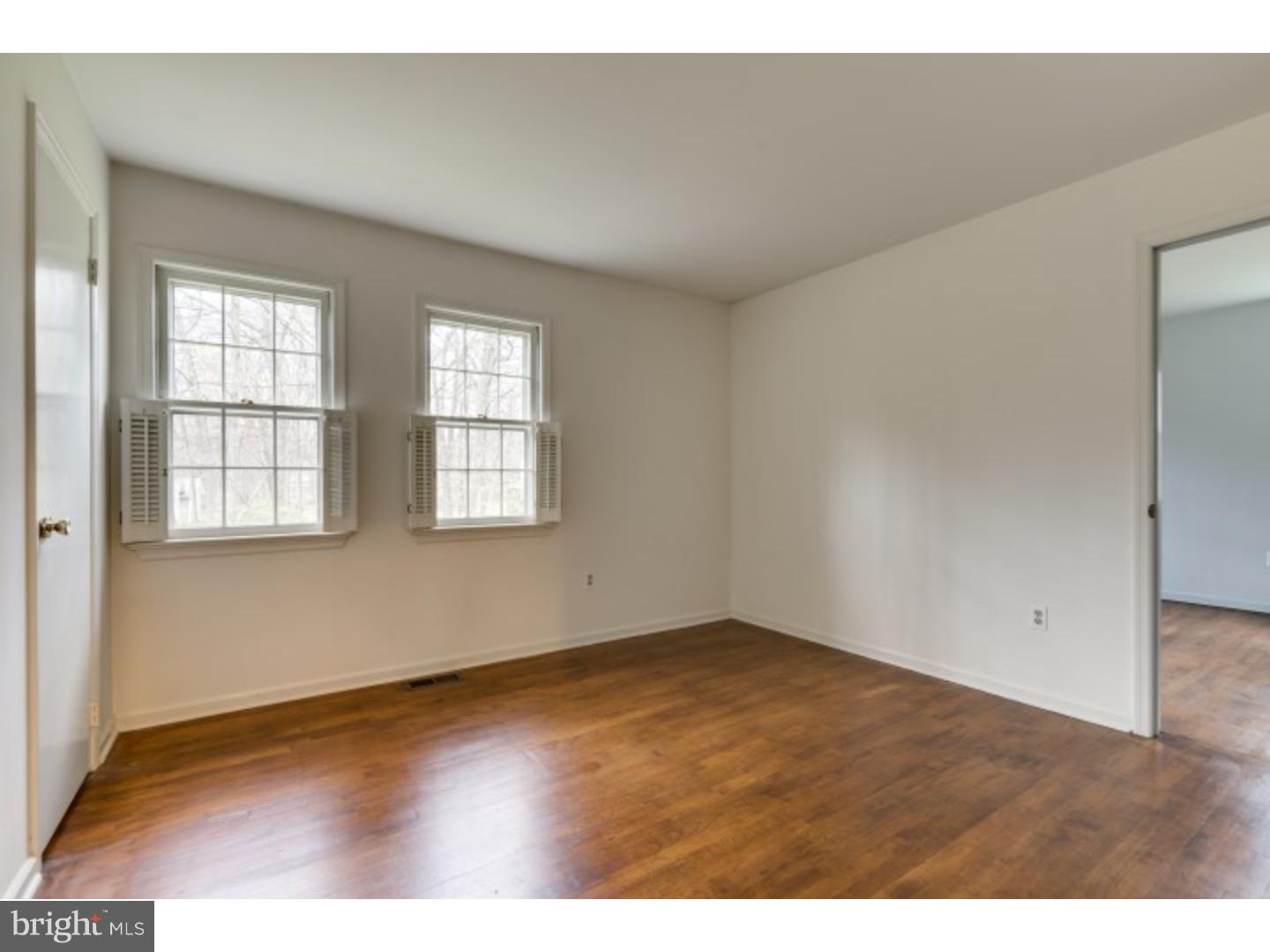 20 Sunset Road Lawrence Township, NJ 08648 - Photo 15 of 25 an empty room with wooden floor and windows