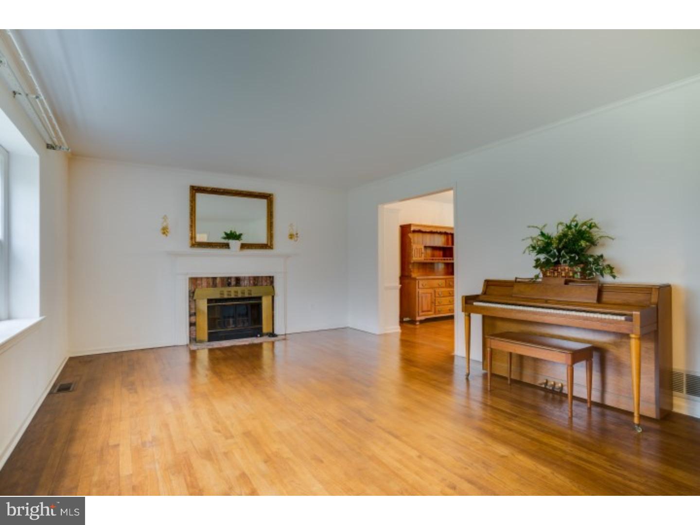20 Sunset Road Lawrence Township, NJ 08648 - Photo 3 of 25 a view of an empty room with wooden floor and a fireplace