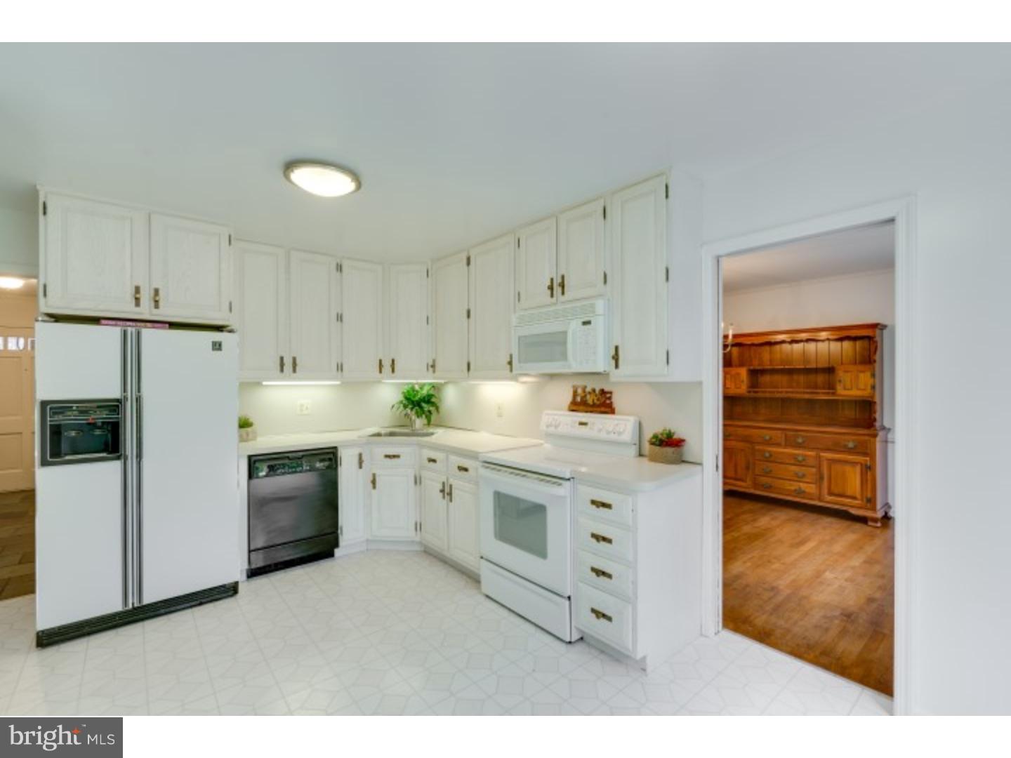 20 Sunset Road Lawrence Township, NJ 08648 - Photo 5 of 25 a kitchen with white cabinets and white appliances