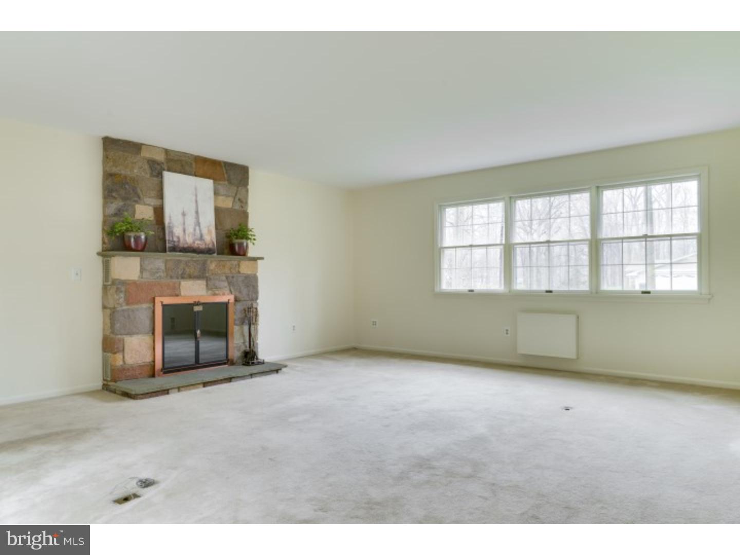 20 Sunset Road Lawrence Township, NJ 08648 - Photo 7 of 25 a view of an empty room with a fireplace and a window