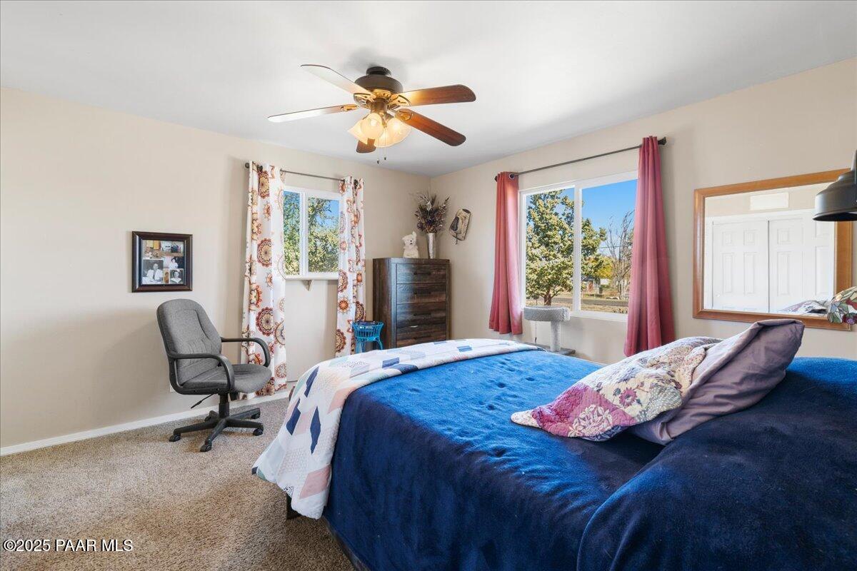 470 South Dewey Road Dewey-Humboldt, AZ 86327 - Photo 13 of 29 a bedroom with a bed and wooden floor