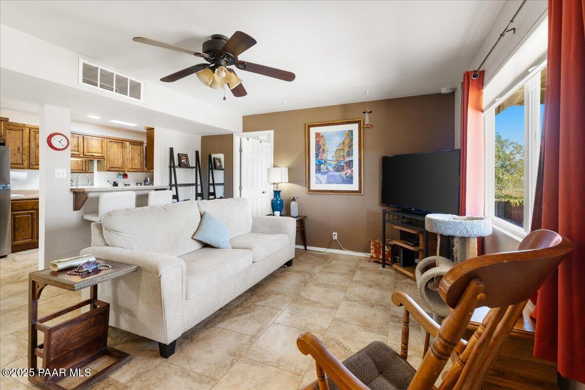 470 South Dewey Road Dewey-Humboldt, AZ 86327 - Photo 2 of 29 a living room with furniture a flat screen tv and a window