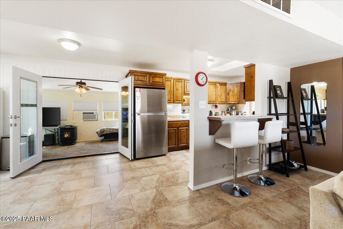 470 South Dewey Road Dewey-Humboldt, AZ 86327 - Photo 5 of 29 a kitchen with refrigerator and chairs