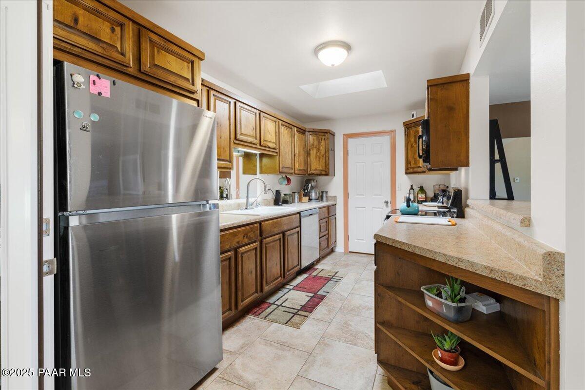 470 South Dewey Road Dewey-Humboldt, AZ 86327 - Photo 6 of 29 a kitchen with stainless steel appliances granite countertop a refrigerator a sink and a stove