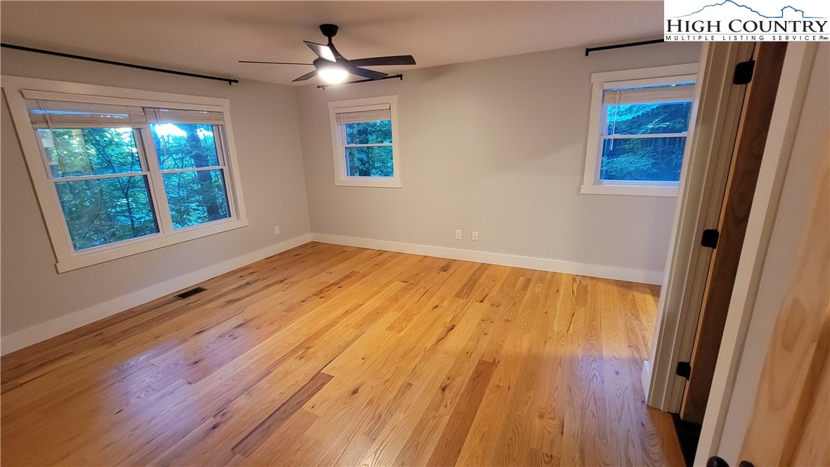 526 Hidden Valley Circle Boone, NC 28607 - Photo 12 of 29 a view of an empty room with wooden floor and a window