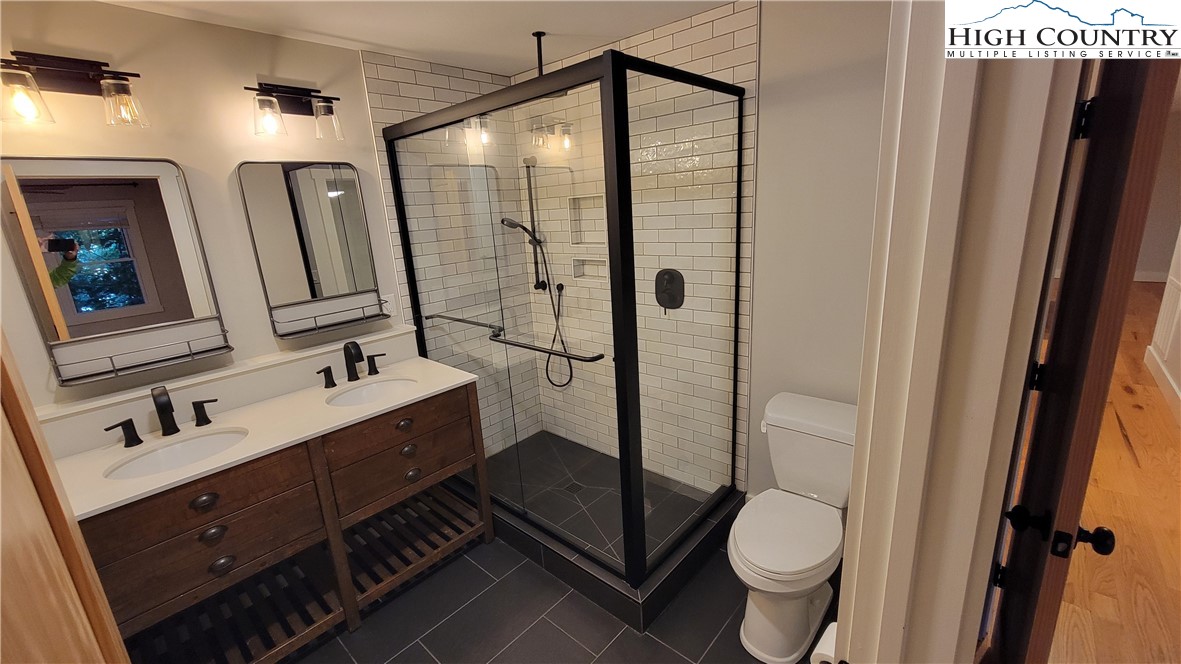 526 Hidden Valley Circle Boone, NC 28607 - Photo 16 of 29 a bathroom with a double vanity sink toilet and mirror