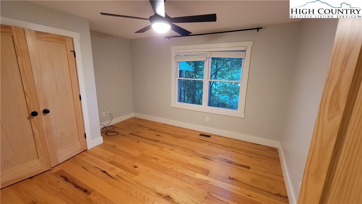 526 Hidden Valley Circle Boone, NC 28607 - Photo 21 of 29 a view of an empty room with wooden floor and a window
