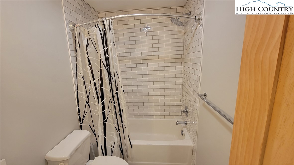 526 Hidden Valley Circle Boone, NC 28607 - Photo 22 of 29 a bathroom with a shower toilet and tub