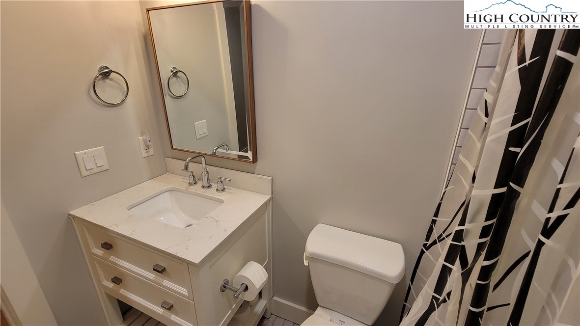 526 Hidden Valley Circle Boone, NC 28607 - Photo 24 of 29 a bathroom with a sink mirror vanity and toilet